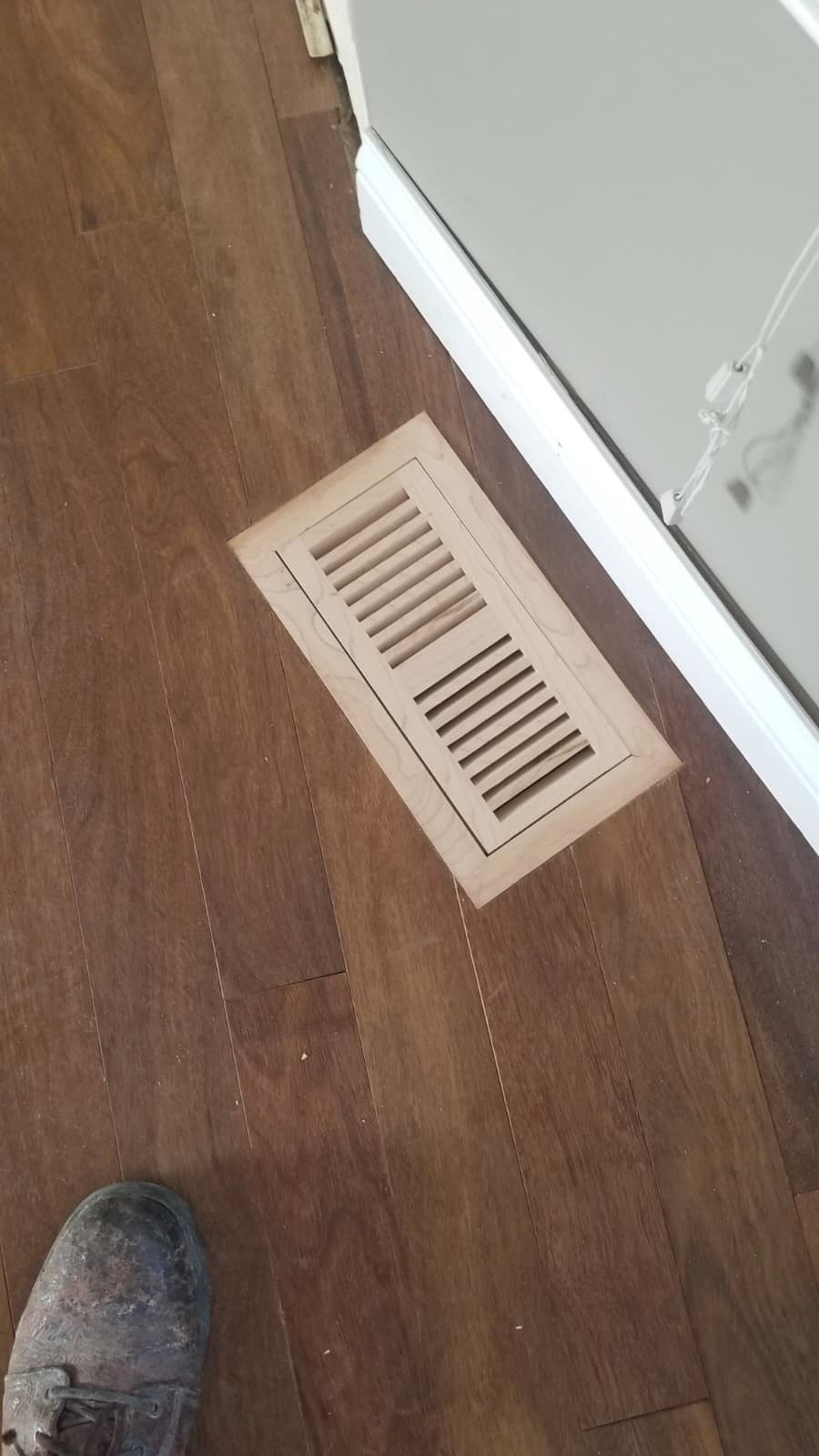 Custom wood floor vent installed in existing prefinished hardwood floor