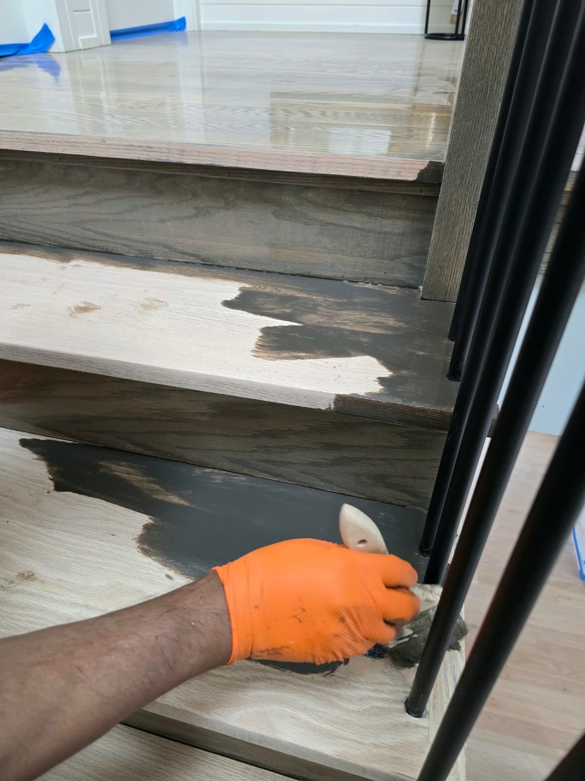 Stain application during hardwood stair refinishing