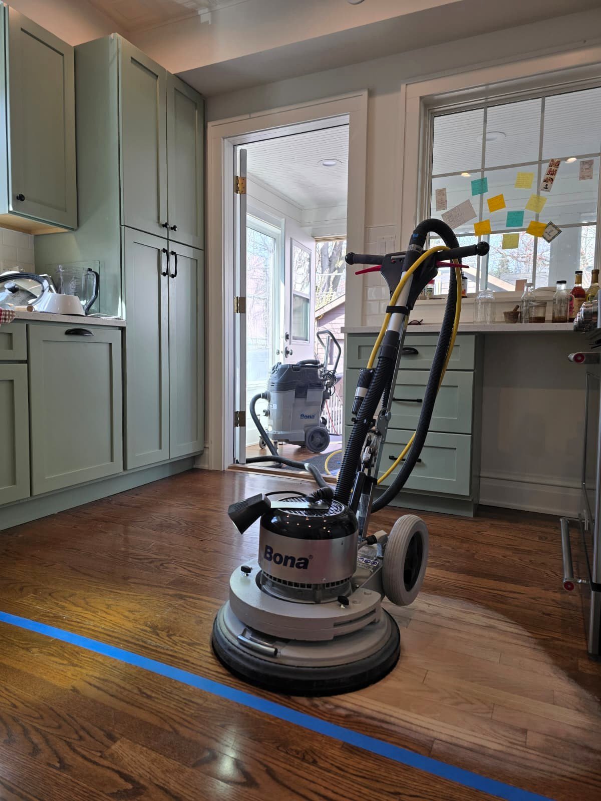 Bona PowerDrive sanding hardwood floor during localized scratch repair