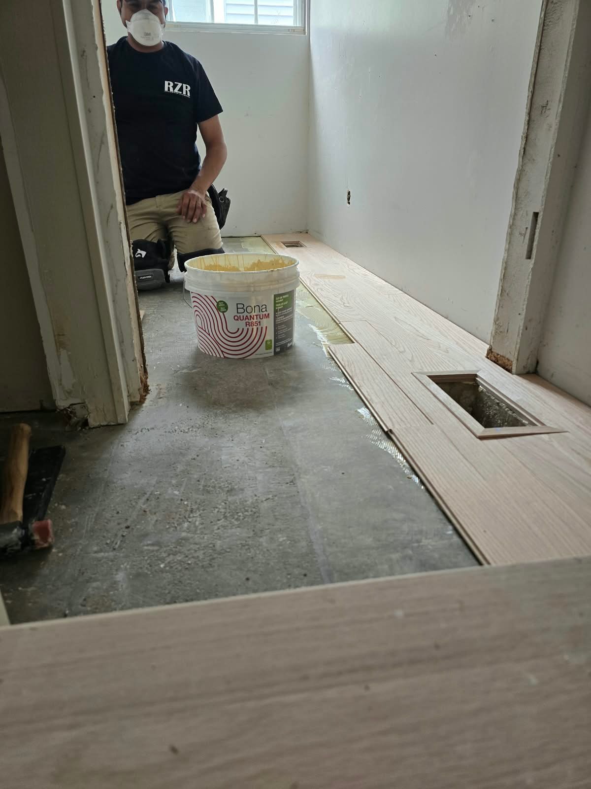 Unfinished engineered hardwood full glue-down installation over concrete