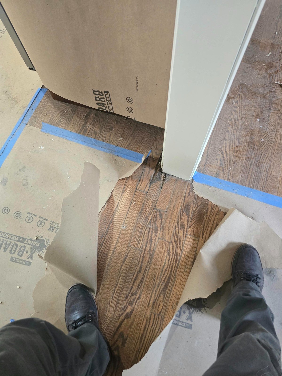 Localized hardwood floor water damage exposed during initial evaluation